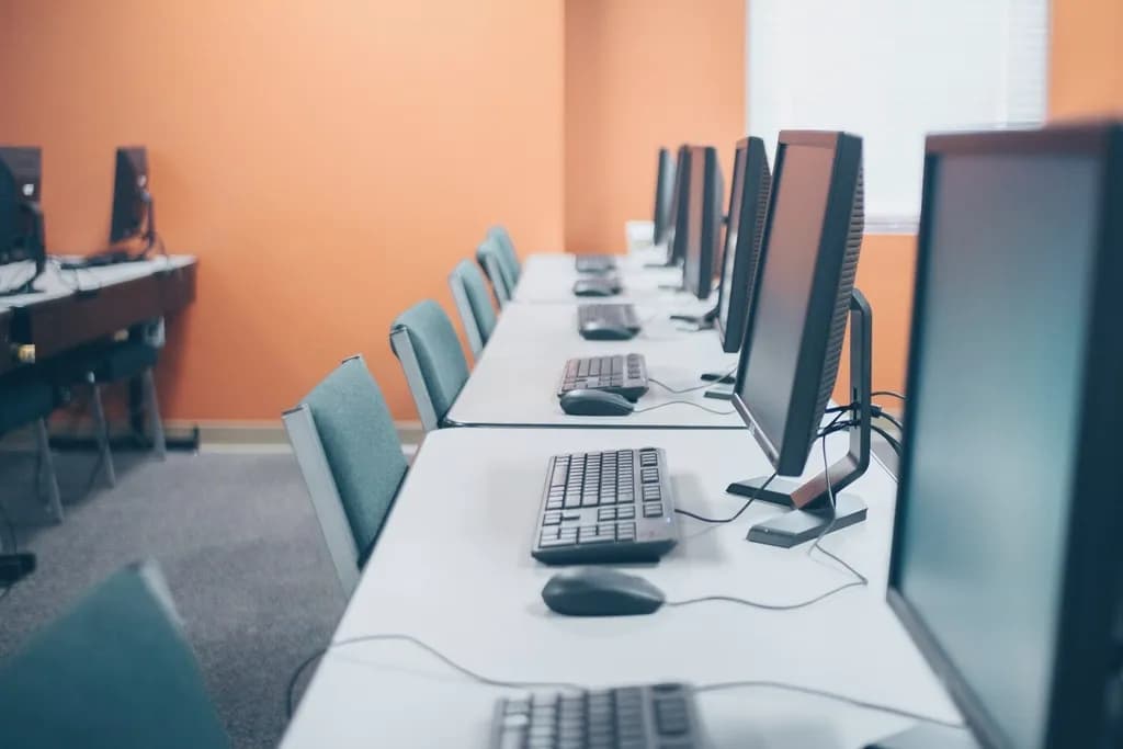 Rows of workstations in an office, representing an in-house AI team